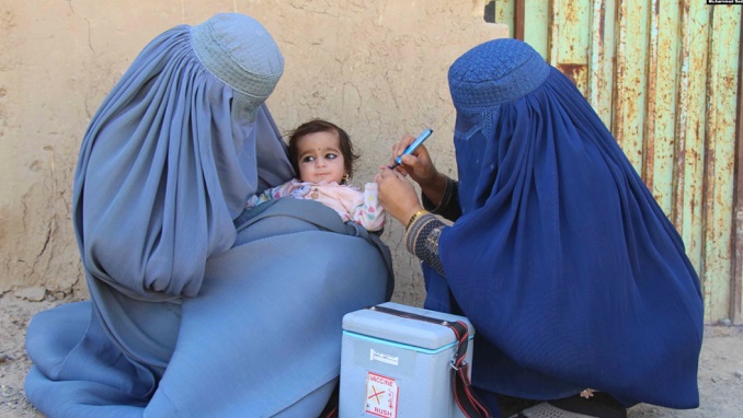 child receiving an immunization in Afghanistan