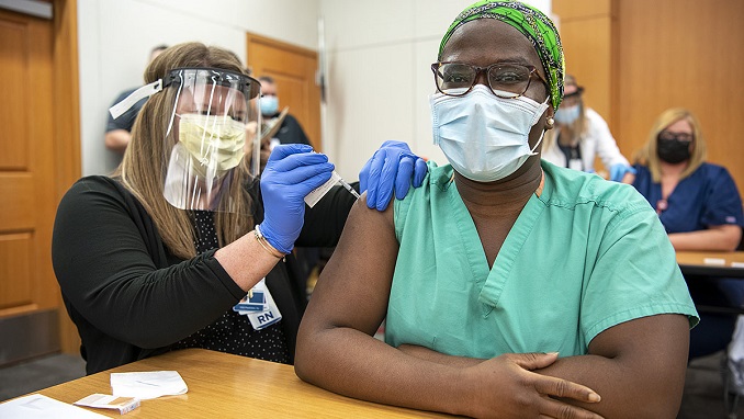 Black patient getting vaccinated during COVID-19