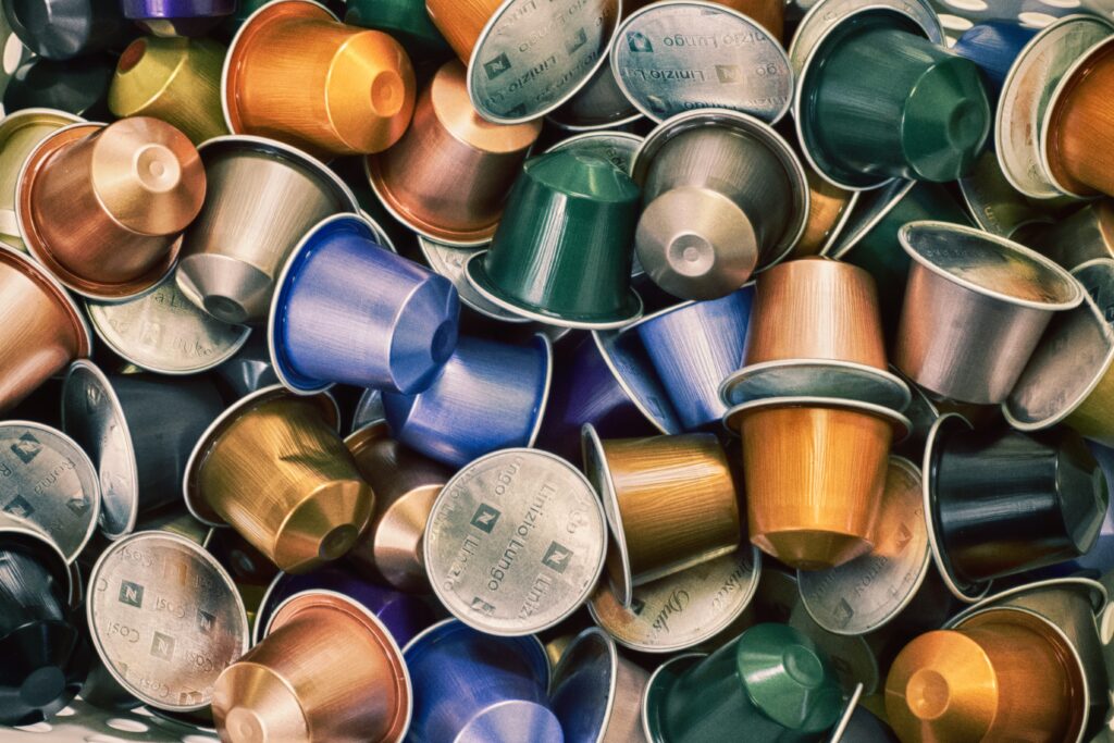 a pile of assorted colorful single-use coffee pods