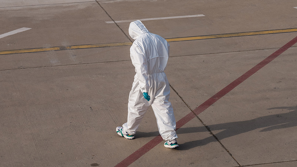 person wearing a hazmat suit and PPE during a pandemic