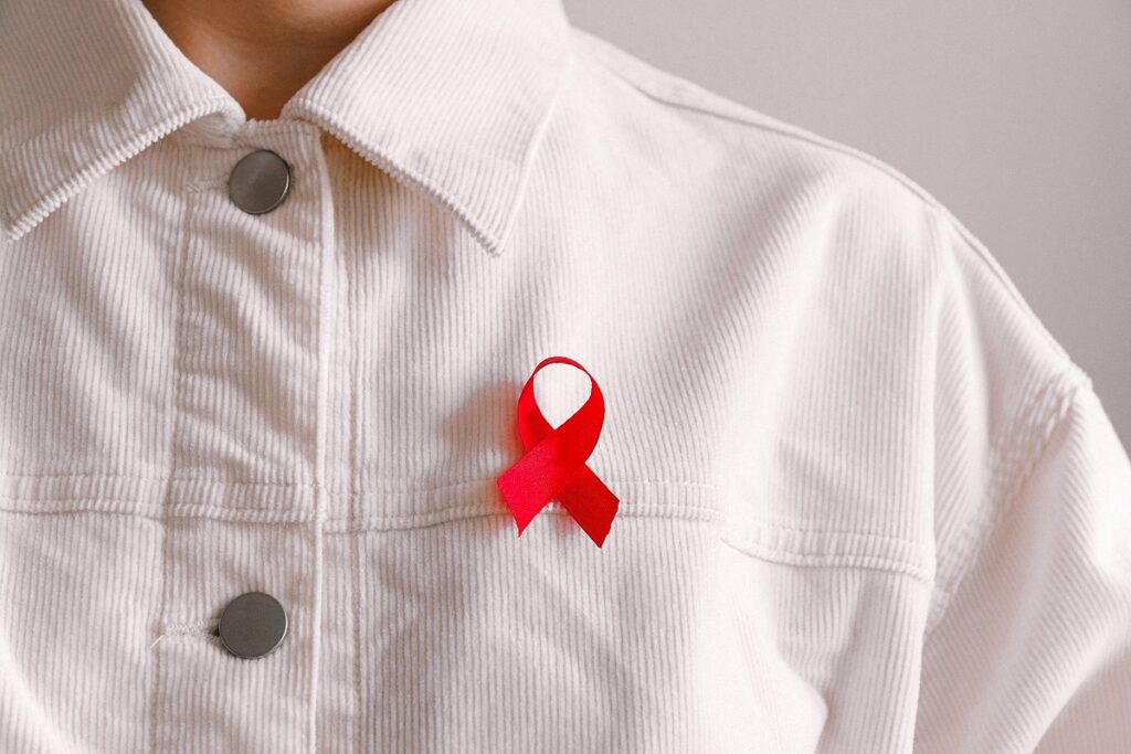 person wearing an HIV AIDS red ribbon
