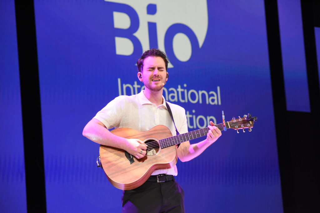 Andrew Marcus plays guitar at Bio International Convention
