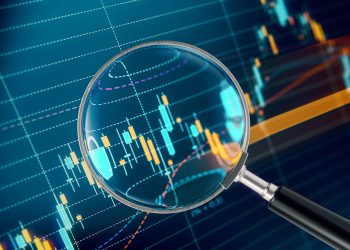 Magnifier Focusing On A Financial and Technical Data Analysis Graph Magnifier focusing on a financial data analysis graph. Selective focus. Horizontal composition with copy space.