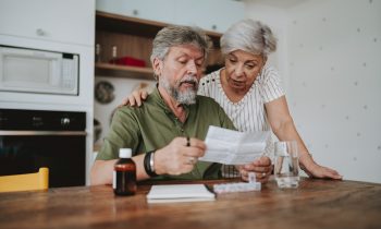 Senior couple medicating at home with medical prescription