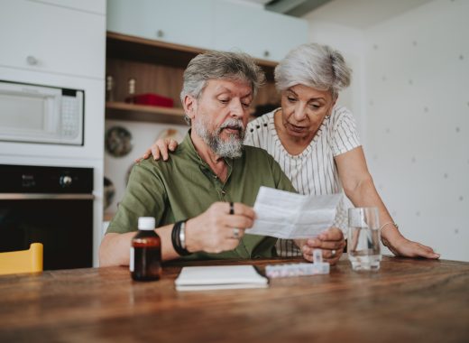 Senior couple medicating at home with medical prescription