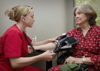 a patient receiving a blood pressure screening