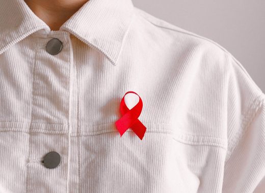 person wearing an HIV AIDS red ribbon